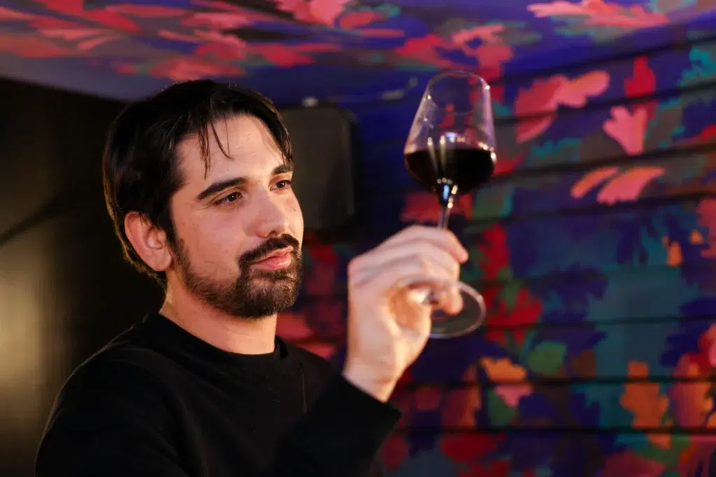 Local guide pouring wine on a Paris food tour in Montmartre